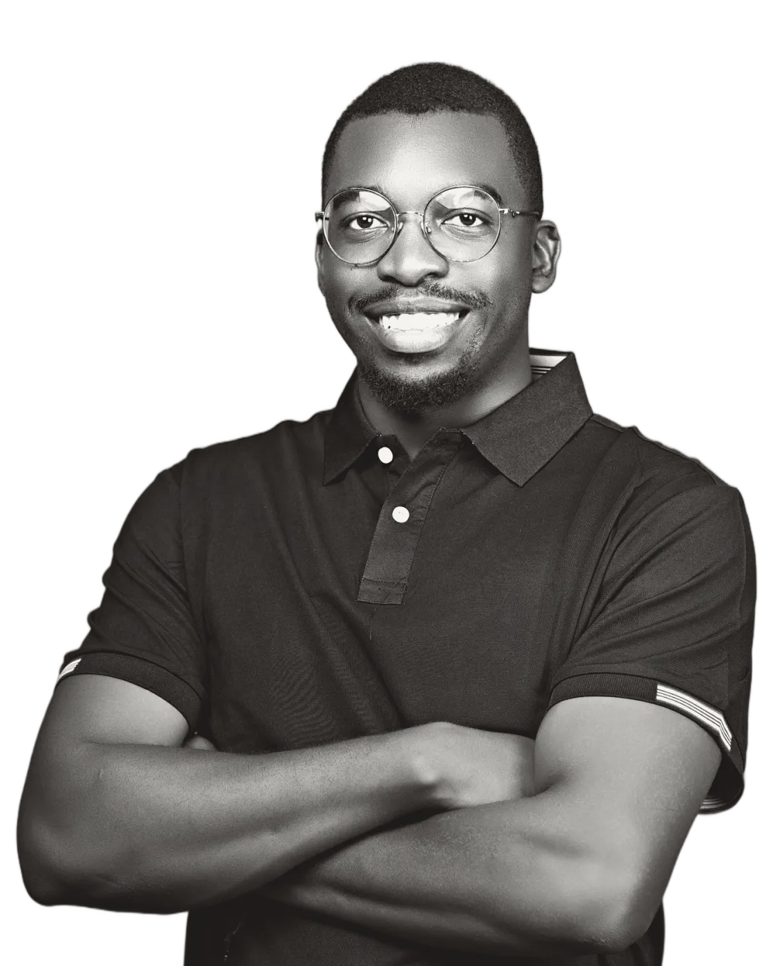 Tanaka Sande, founder of Anti-Formula, smiling, arms crossed, wearing round wire glasses and a polo shirt. Black-and-white portrait.